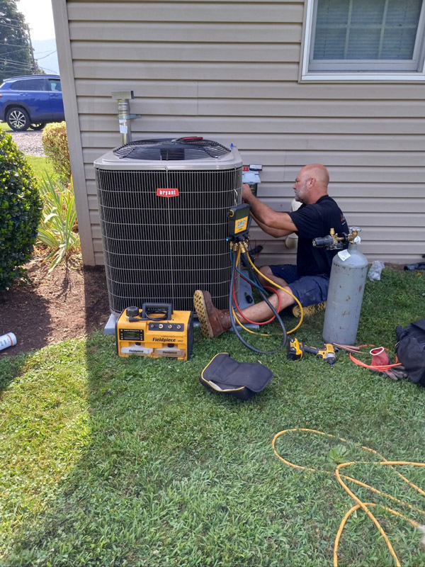 mgm mechanical team member working on a residential hvac unit outside